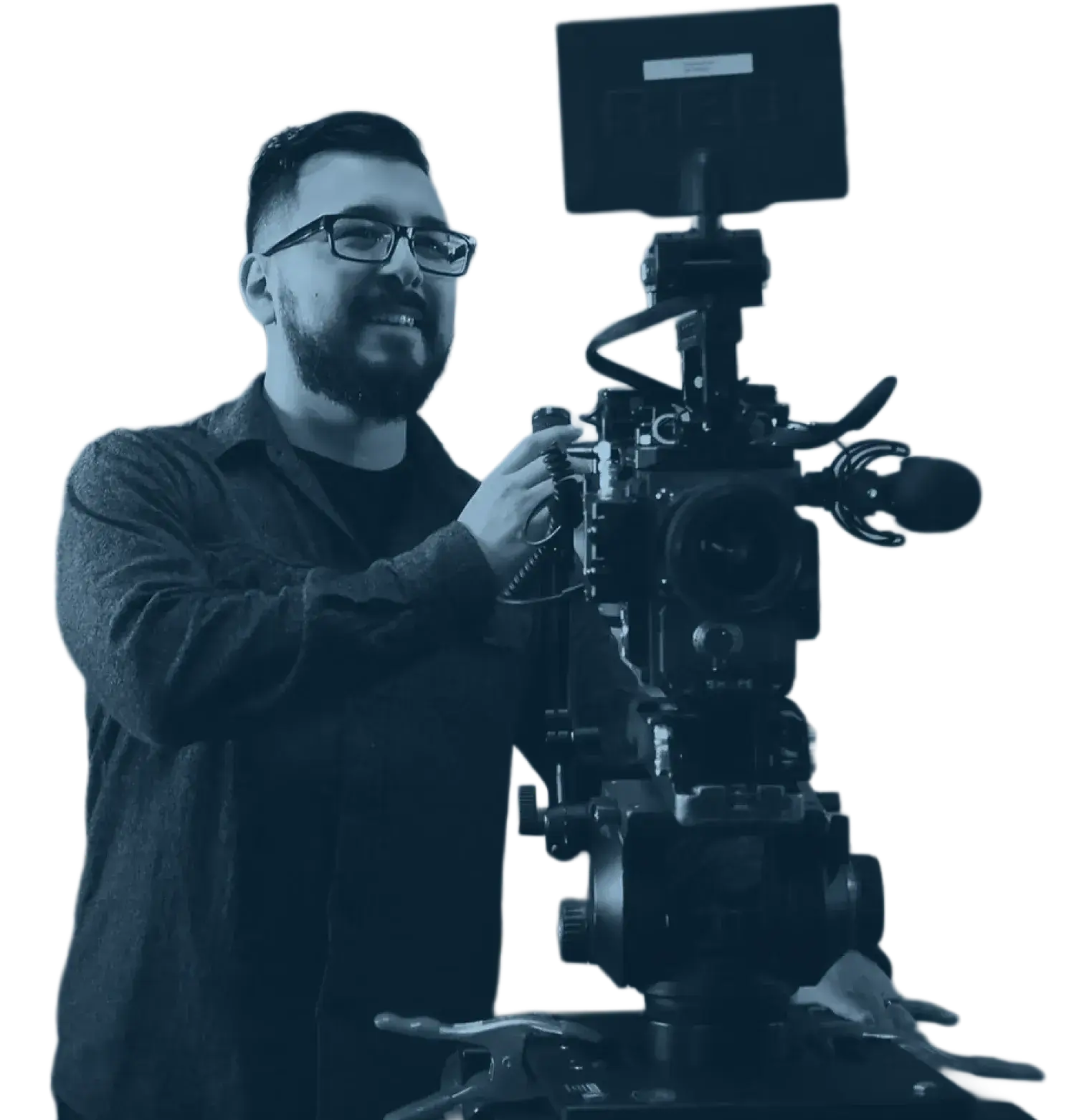 A man with glasses and a beard operates a professional video camera mounted on a tripod, smiling as he adjusts the equipment.